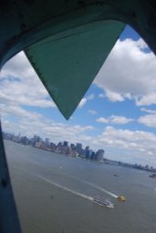 looking out of statue of liberty at Manhattan